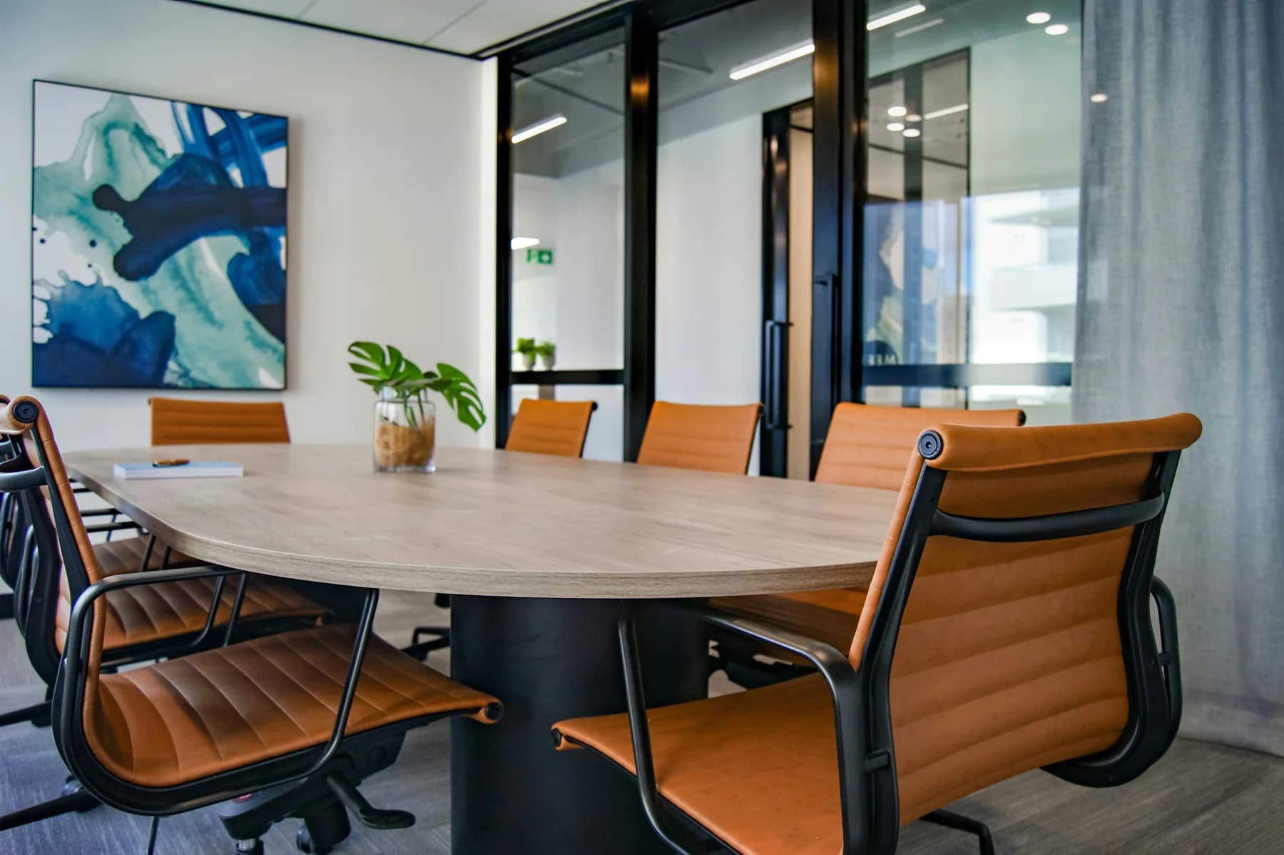 Grande table de réunion en bois entourée de fauteuils